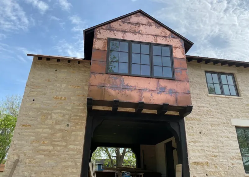 Copper metal panel facade on a stone building for Skylight Installation in Sandersville