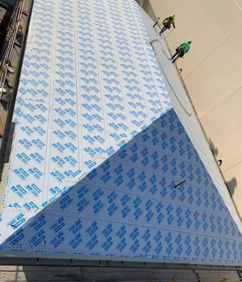 Professional roofers installing underlayment on a metal roof in Sandersville